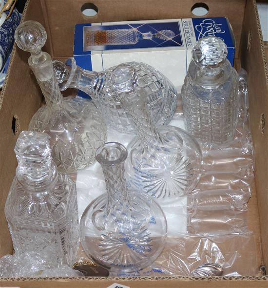 A collection of cut glass and pressed glass decanters